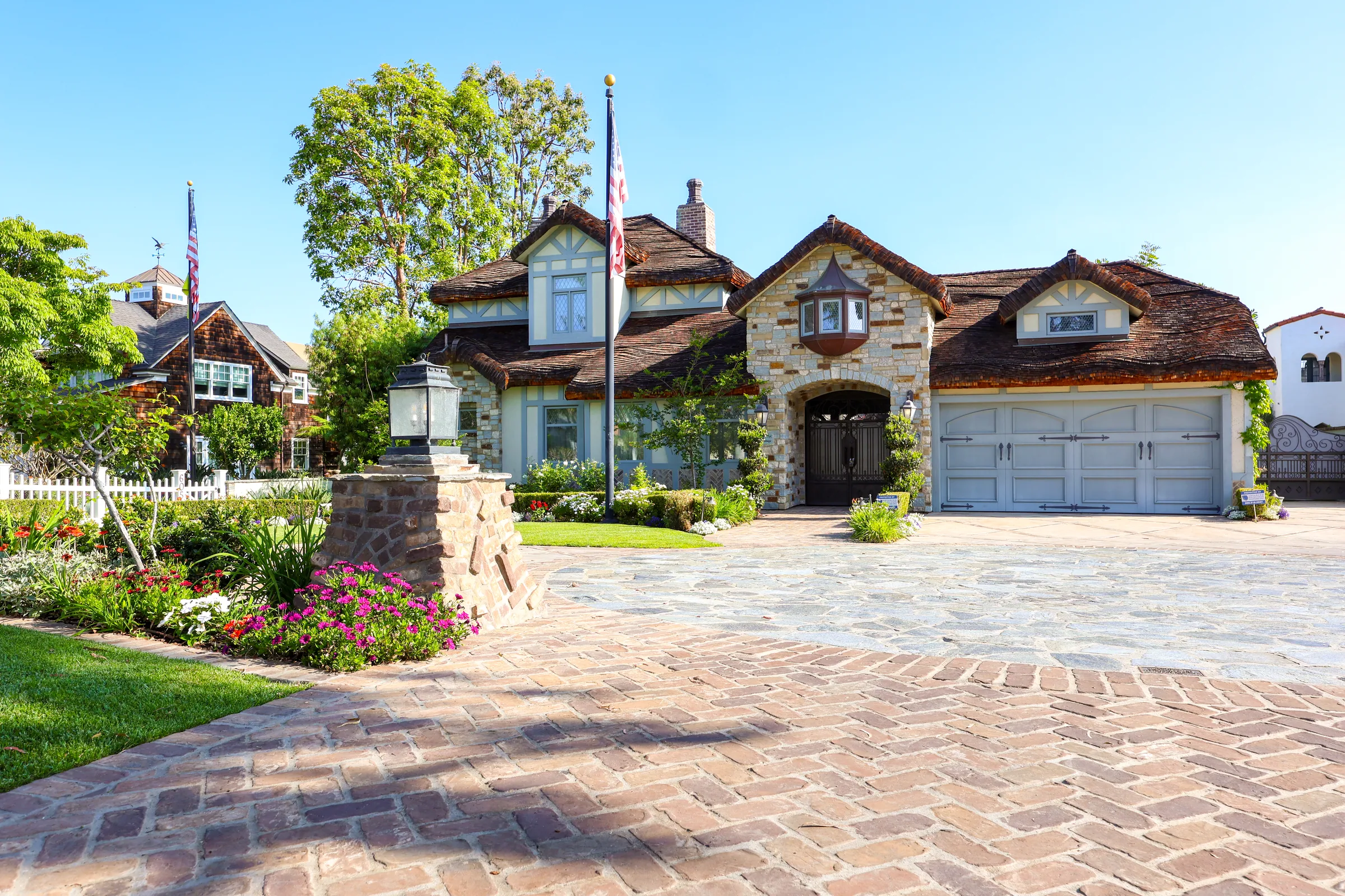 Brick driveway and stone arch entry, Tudor estate hardscape