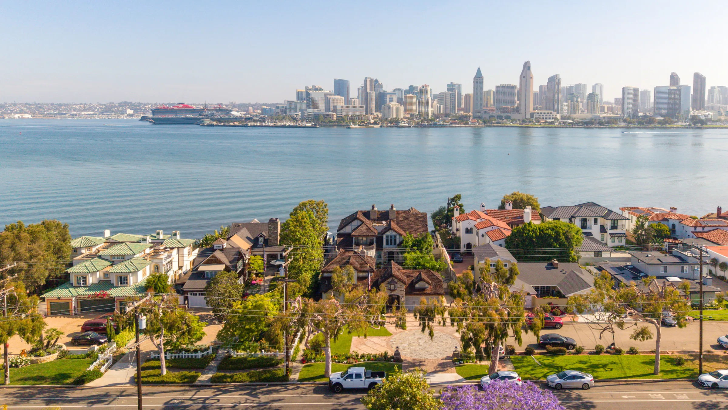 Aerial view of Coronado homes along the bay with downtown San Diego beyond