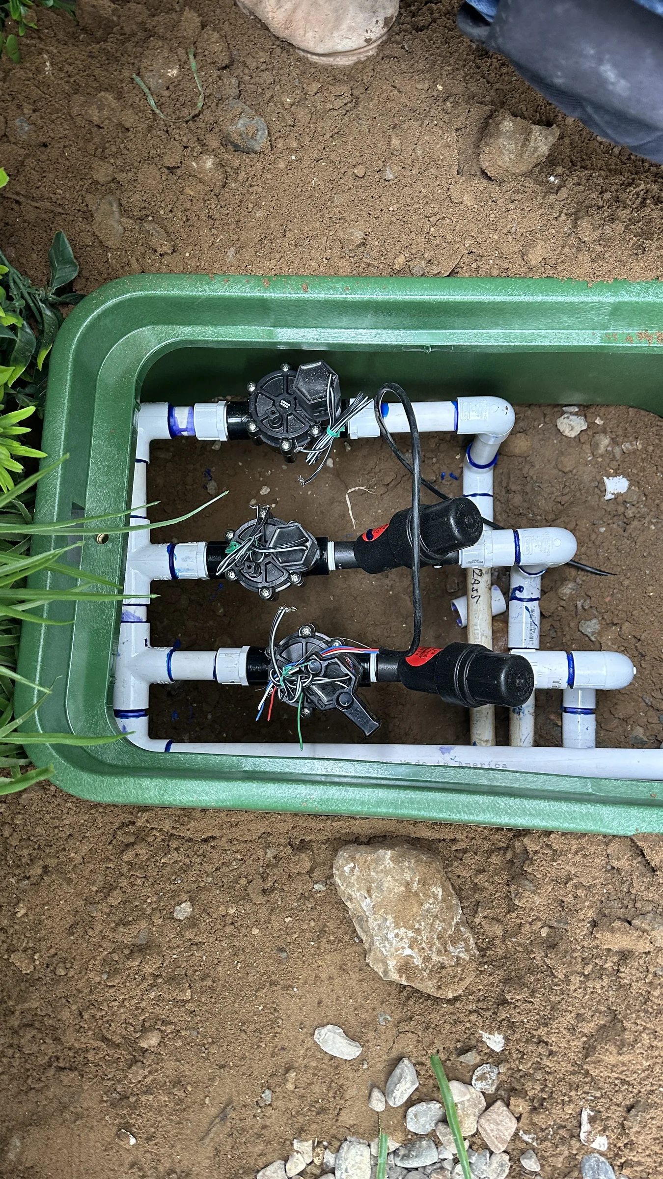 Irrigation manifold with multiple valve zones installed by Ecosystem Landscaping
